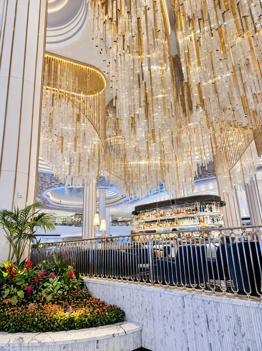 Fontainebleau Las Vegas, a crystal chandelier over a bar ringed by a balcony