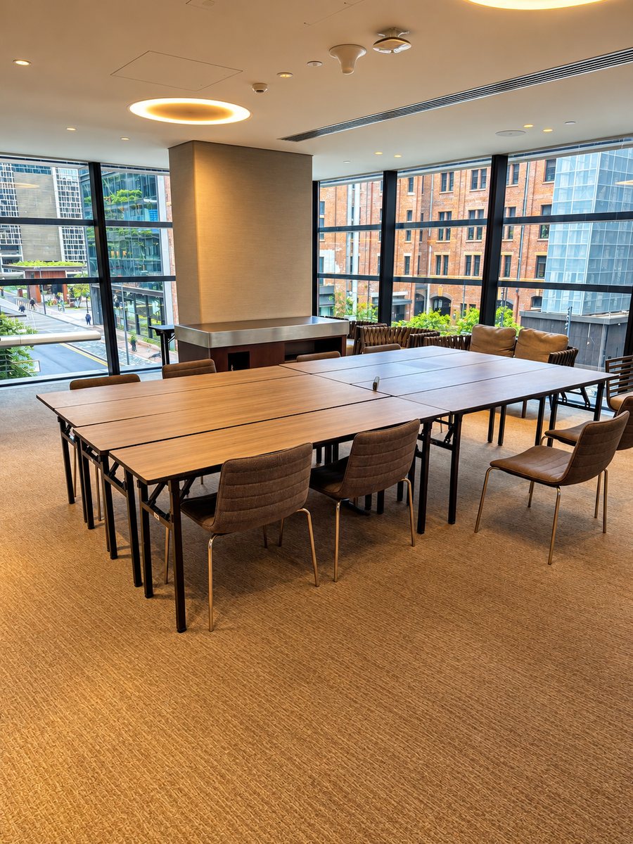 Four Points by Sheraton Sydney, Central Park, meeting tables set in a block under floor to ceiling windows looking over red brick warehouses