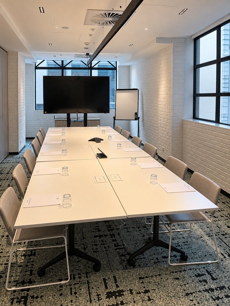 Holiday Inn Melbourne Bourke Street Mall, meeting room set boardroom style, with a screen on a stand and a flip chart