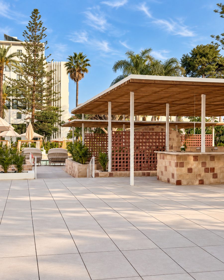 Kimpton Los Monteros Marbella, pool bar under a slatted timber pergola with a terracotta block screen