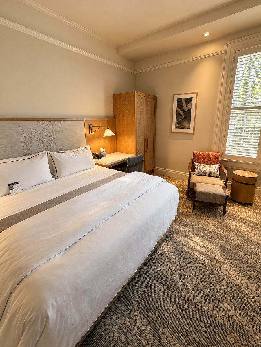 Moana Surfrider, A Westin Resort & Spa, a guest room with a king bed and plantation shutters
