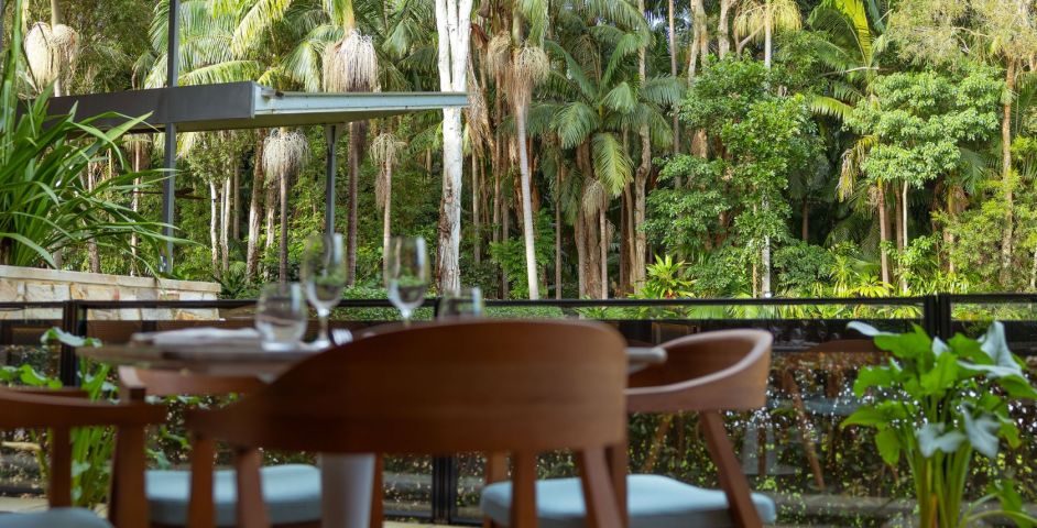 Crystalbrook Byron, a dining terrace looking into the rainforest