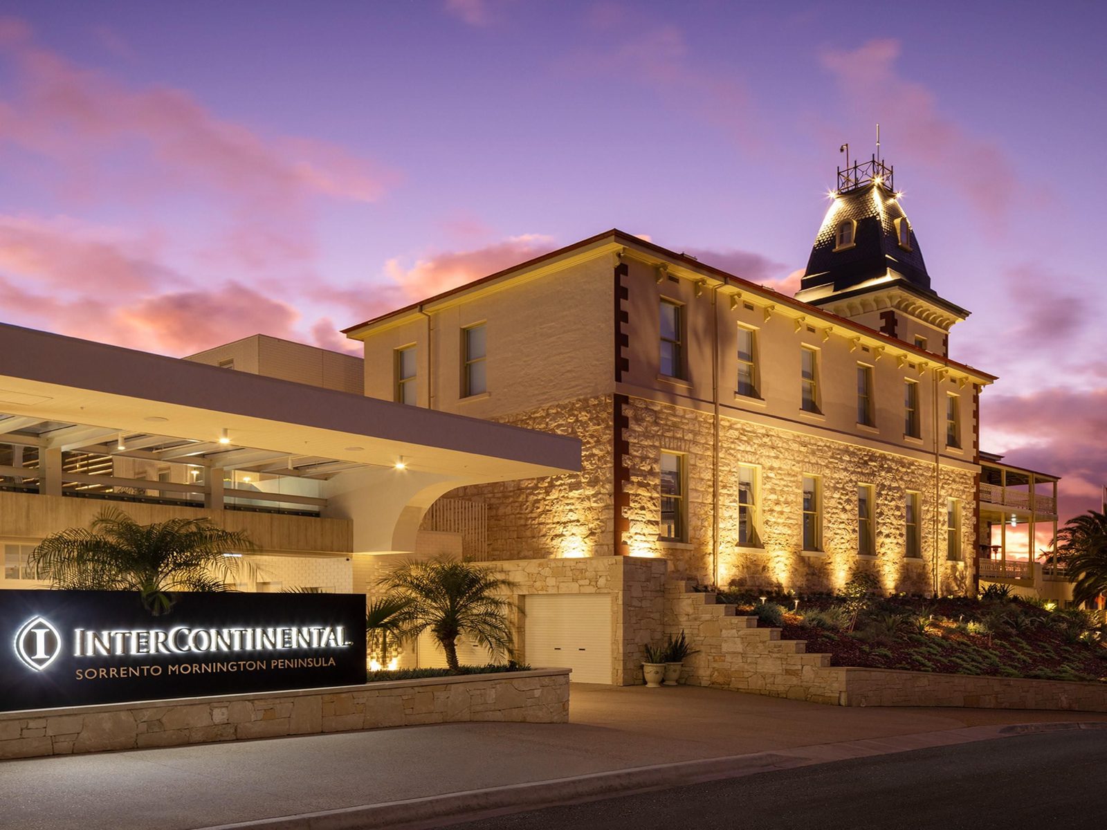 InterContinental Sorrento, the heritage limestone hotel and tower lit at dusk